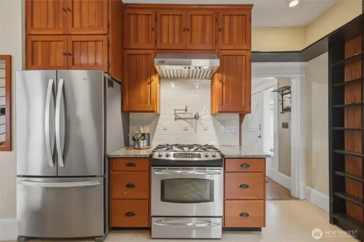 Well-appointed kitchen with granite counters, stainless appliances, and custom wood cabinetry