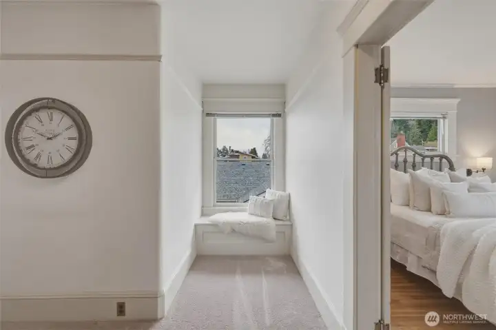 Charming second-level landing with built-in window seat—perfect for a quiet reading nook.