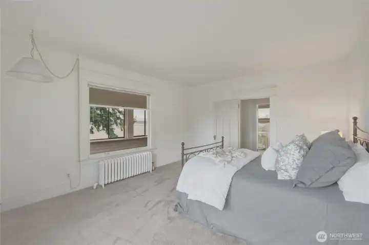 “Spacious bedroom with bay views and easy access to the charming sun porch