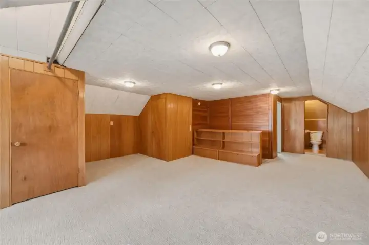 Third-level bonus room with built-in shelving and convenient half bath
