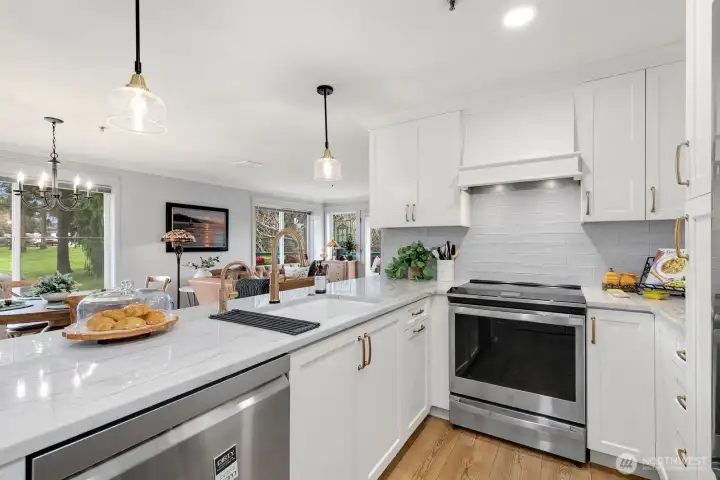 Kitchen with quartz countertops, tile backsplash, stainless steel appliances.  Everything is new as-of 2024!