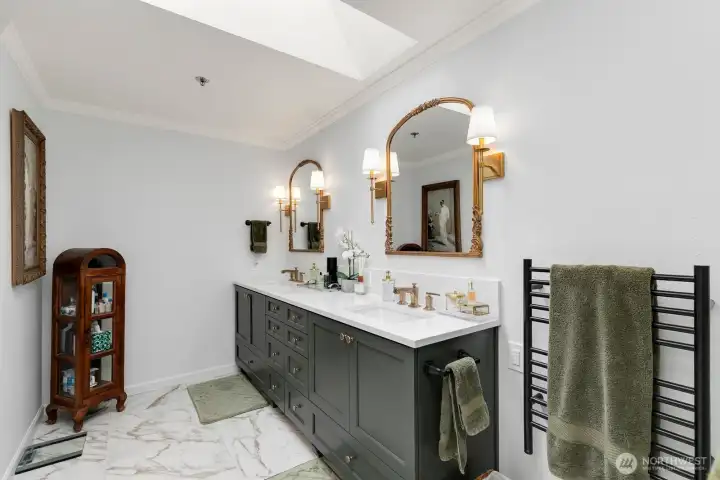 Skylight in primary bathroom, two sinks and heated towel rack near shower!