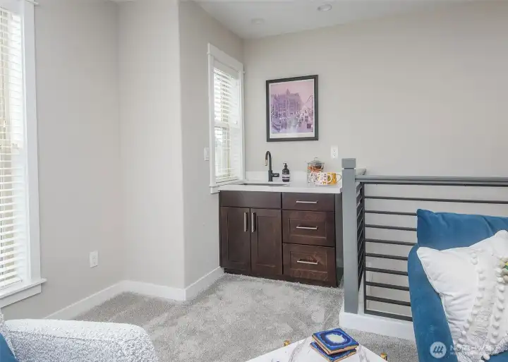 Third floor living area with a wet bar.