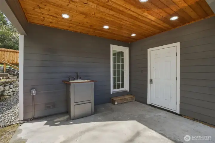 Covered year-round weather-protected access to outdoor storage area.