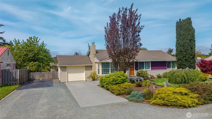 Attached single car garage with plenty of extra parking on either side.