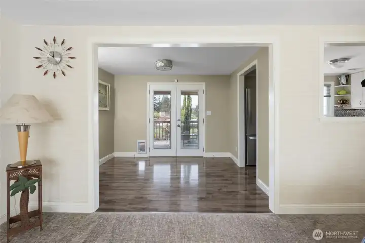 French doors lead out to covered back deck.