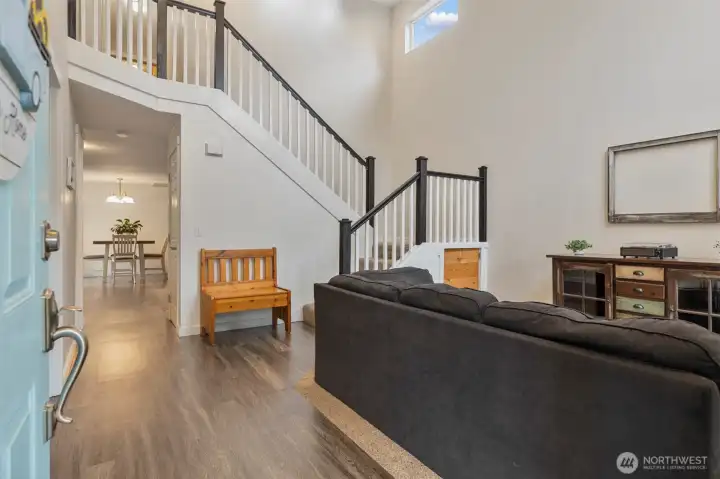 You are welcomed into the living room with cathedral ceilings, and open staircase.