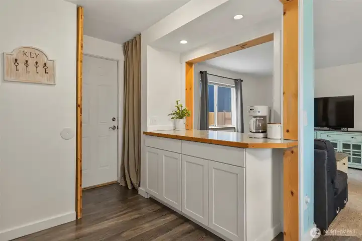 Door from side of home/RV parking w/ entertainer's bar overlooking family room