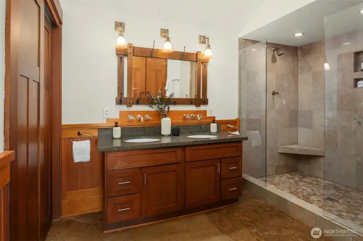 The private primary bathroom has double sinks and an oversized shower with dual heads and dual benches. The private primary bathroom has double sinks and an oversized shower with dual heads and dual benches.