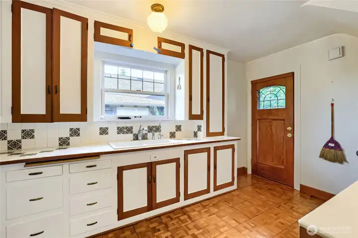 Kitchen with Exterior door to yard. To the right is the doorway to the lower level Kitchen with Exterior door to yard. To the right is the doorway to the lower level