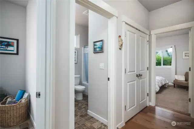 Hall bathroom serves both secondary bedrooms and has a window, offering natural light and ventilation.