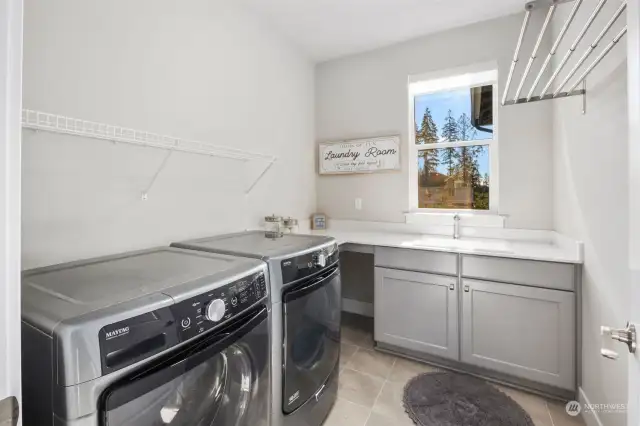 Laundry room with sink and drying racks