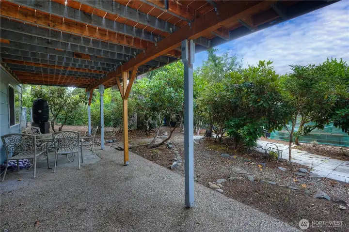 Great patio space outside of the downstairs rec room with walking paths through the garden.