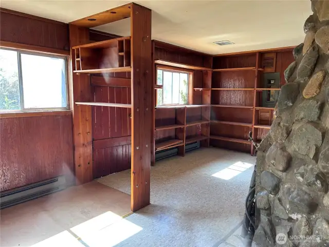 Built in Bookcases for hobbies or office or clear out for more living area.  Backdoor behind tall bookcase