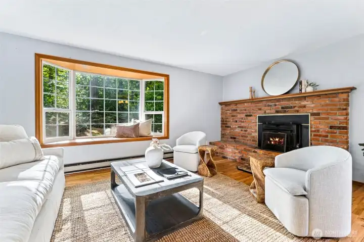 Living room features a wood burning fireplace with large brick mantle