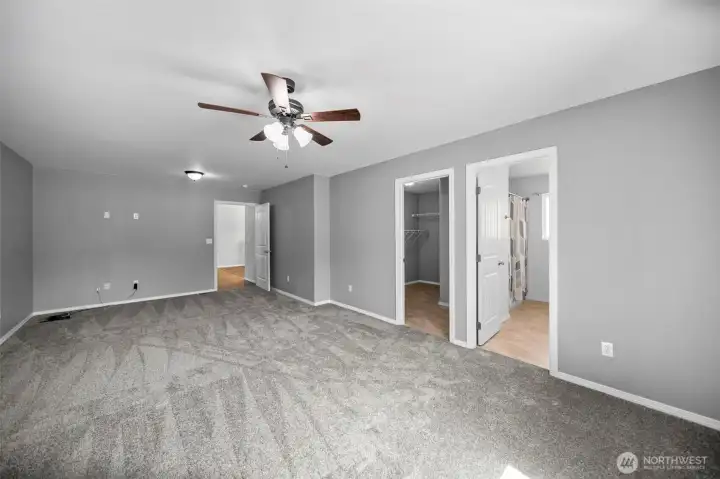 Primary Bedroom looking towards living room, walk-in closet and primary bathroom.