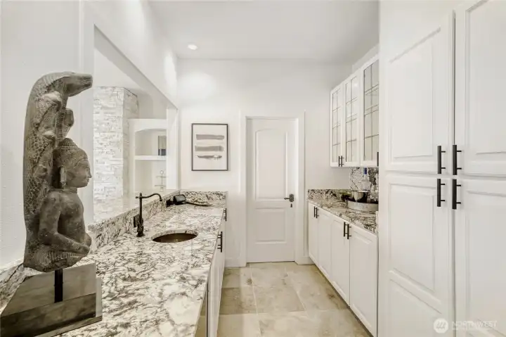 Wet bar with lake view smartly located by the dining room.