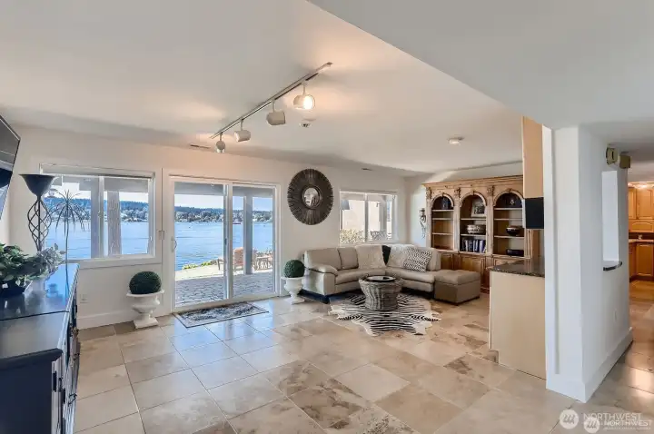 Multi-functional downstairs living room with wet bar doubles as a beachy transition space.