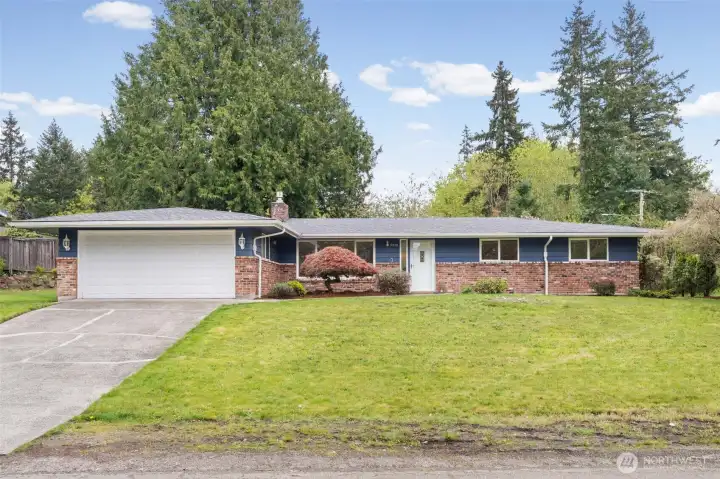 Classic mid-century rambler with timeless brick accents, set on a spacious lot with mature landscaping. Fresh exterior presence offers great curb appeal and a canvas for future updates.