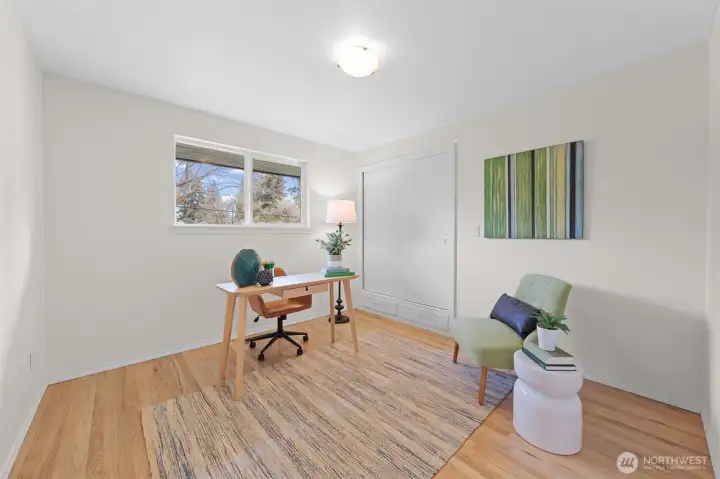 Bedroom Three with large window, wood flooring, and closet storage. Ideal for a home office, guest room, or flex space to fit your needs.