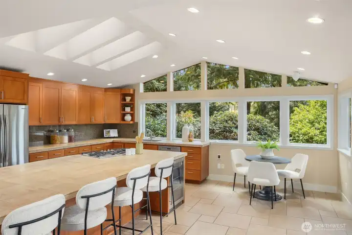 The kitchen is graced with incredible skylights that flood the space with natural light—designed for gathering, entertaining, and connecting with the people you love.