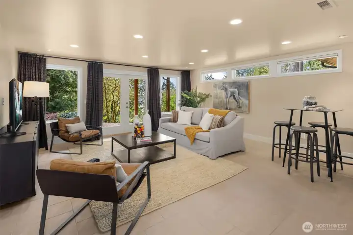 Thoughtfully designed on the main level, this bonus space opens directly to the stunning backyard, creating seamless indoor-outdoor living.