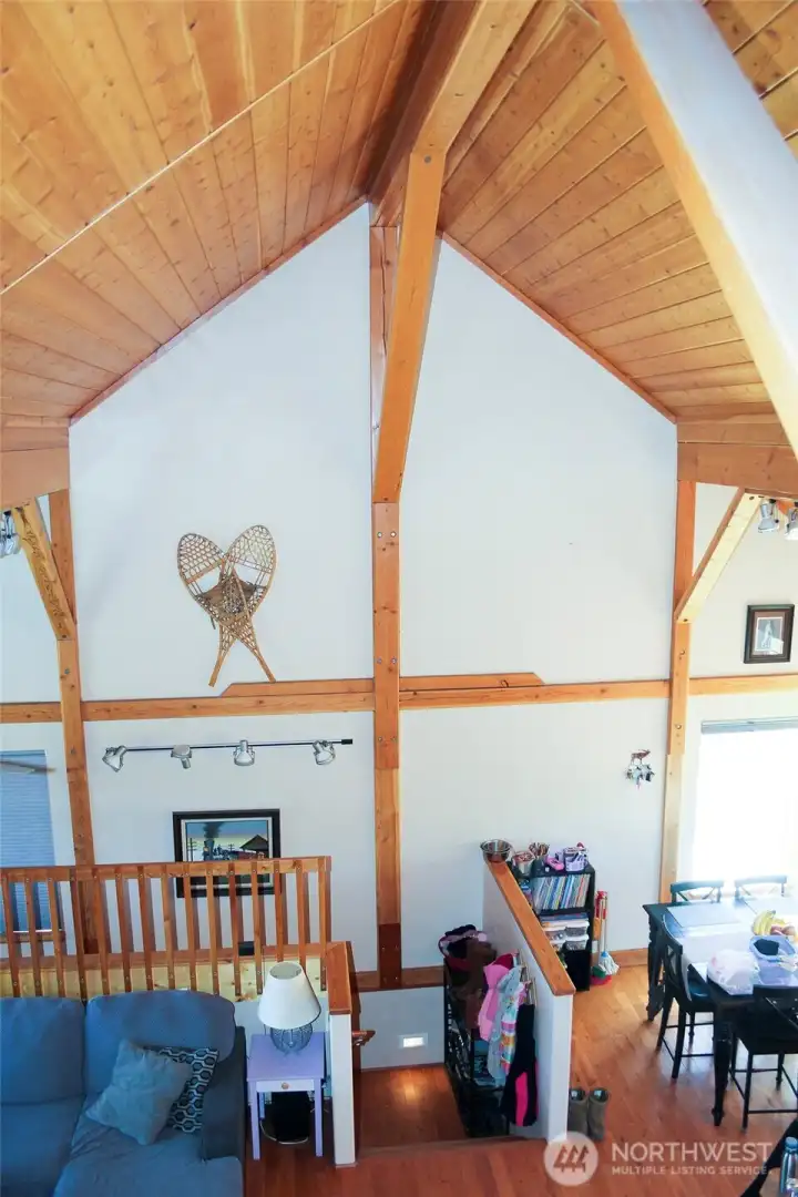 Loft overlooking the main living area with striking wood detail.