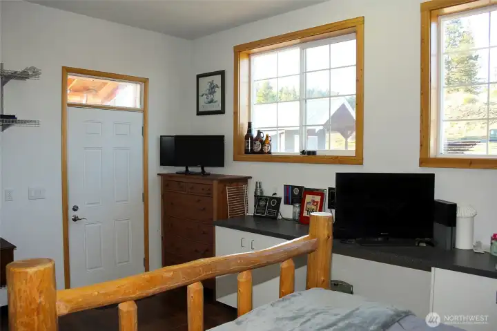 Bedroom with direct access to the outdoors and scenic backdrop.