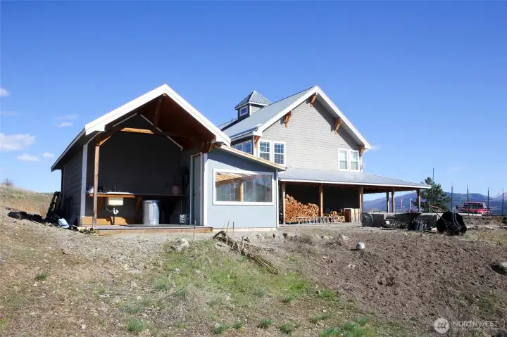 Detached structure with covered outdoor area ideal for storage or workspace.