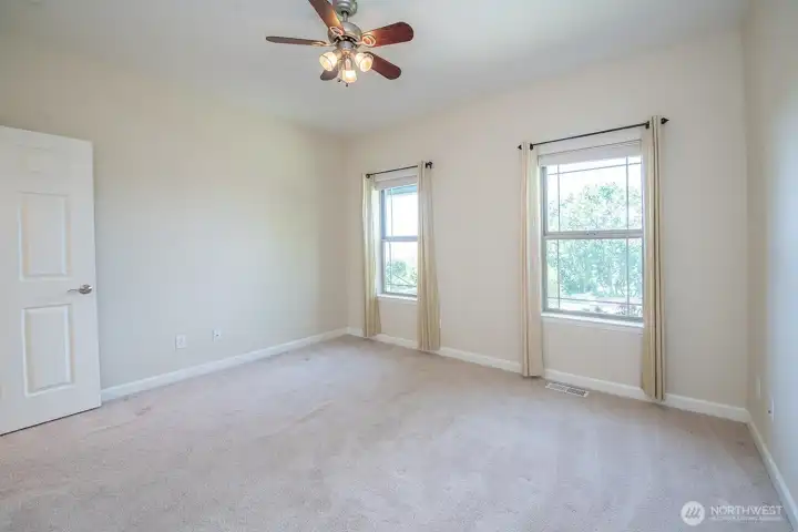Bedroom on the north side of home, ceiling fan and darkening shades