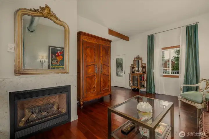 Living room with a front view window and gas fireplace.