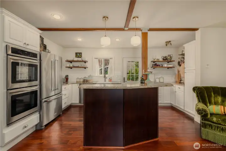 Spacious, sunny and bright upgraded kitchen with a perfect "Chef's" lay-out, granite counters, stainless appliances and wood beamed ceiling.