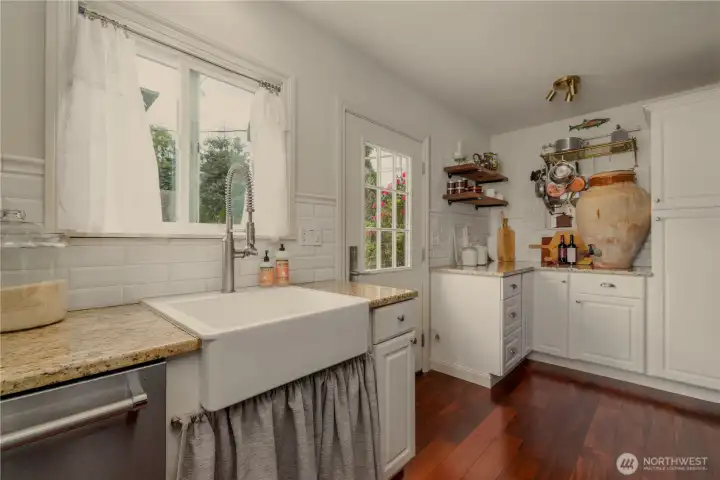 Kitchen has direct access to the back patio for easy entertaining! Also note the ample kitchen pantry cupboards and additional counter space. Perfect for baking!