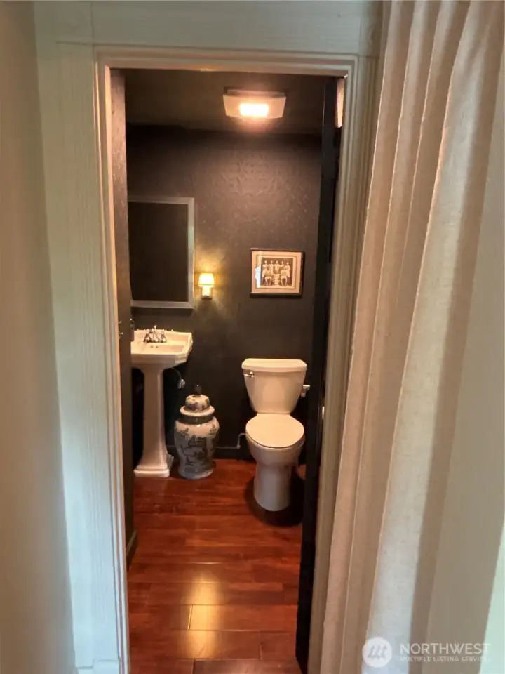 Main floor full bath and right side closet both tucked beneath the staircase at the entrance.