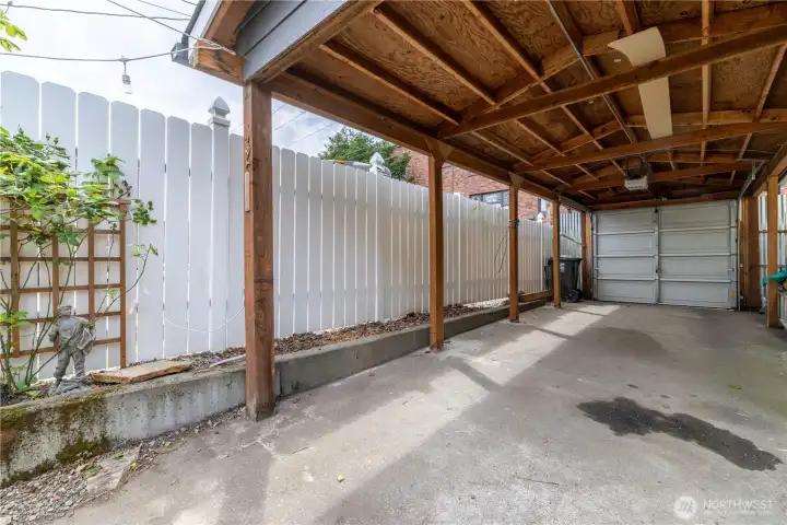 Spacious, newer, tandem (2-car) carport. Fully fenced and opening onto the access alley through an automatic garage door.