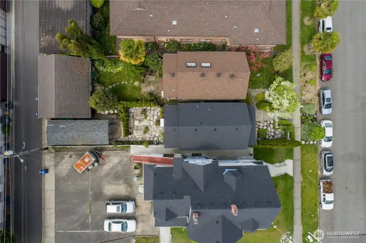 Fully fenced home with large patio in the center with N G Street on the right.   The carport and fully paved back alley access on the left.