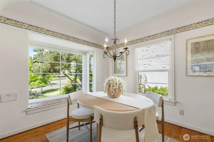 Quaint, bright, proper dining room with bay window.