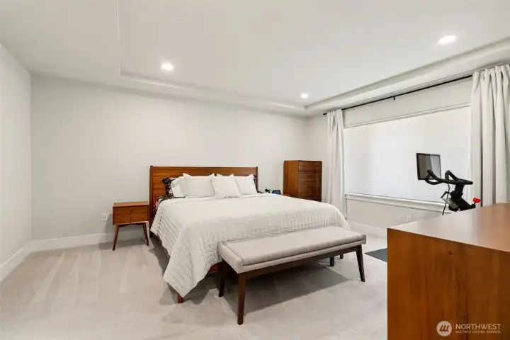 Your private retreat awaits. The oversized primary suite offers soaring tray ceilings, plush carpet underfoot, and generous natural light — a calm, quiet escape at the end of every day. Plenty of room to personalize with your own style.