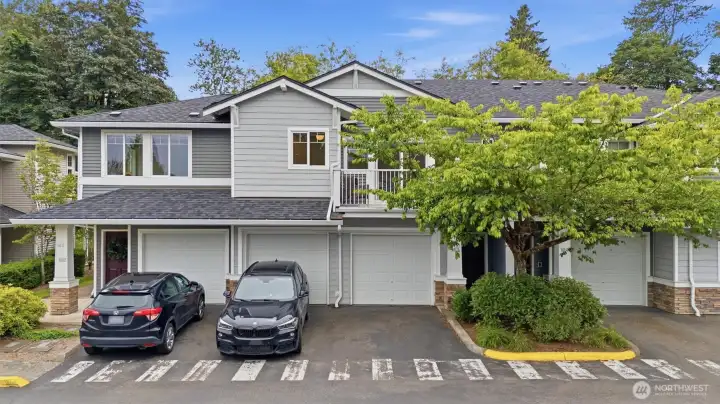 Exterior, parking/ garage nect to car and curb, entry behind tree. Exterior, parking/ garage nect to car and curb, entry behind tree.