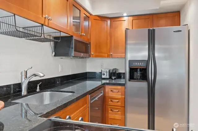 Cherry cabinets, granite counters and stainless steel appliances.