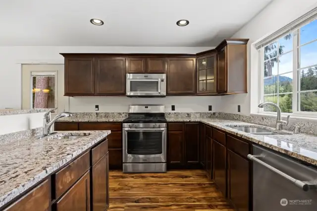 Kitchen with granite counters, soft close drawers, cabinets with pull out storage drawers.