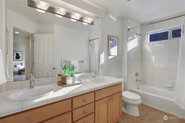 Full Bath on upper floor features dual sinks, shower-tub combo and tile floors.