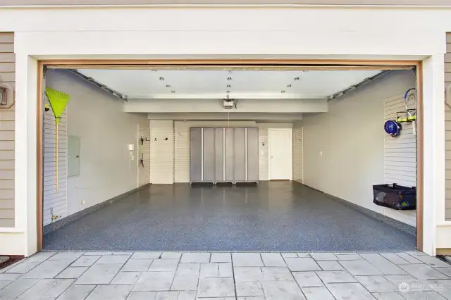 The garage of your dreams! Professionally installed, high-end Floortex epoxied floors, slat walls for hanging storage, spacious storage lockers and freshly painted walls.