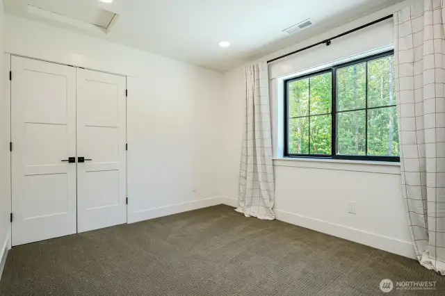 Bedroom #2 with Berber carpeting & double door closet with closet system and pretty backyard views.