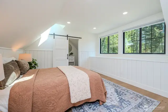 At the end of the upstairs hall you'll find the private guest suite with vaulted ceilings and charming design. Large windows and skylights offer fabulous natural light.