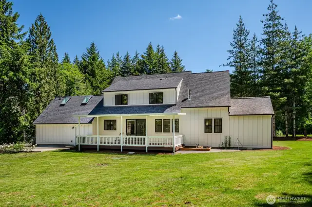 Love the expansive covered backyard deck, the sandbox on the right and additional concrete patio on the left. All of this is perfect for year-round outdoor living! Access your private trails from front and back yards!