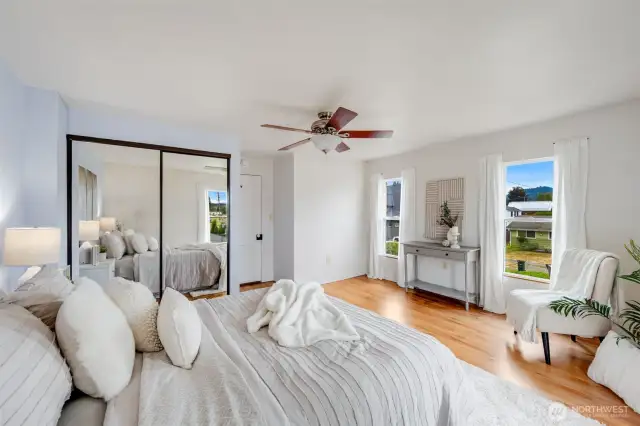 The main bedroom is bathed in natural light for a warm, airy feel.