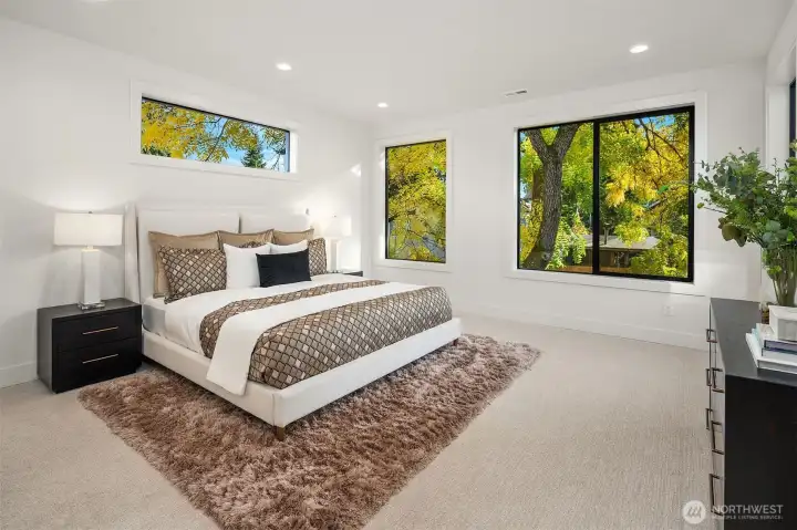 Designer primary suite with five-piece bath with heated floors