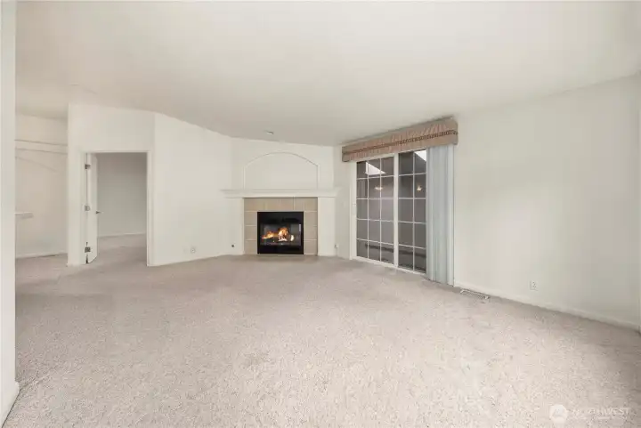 Bonus room with cozy gas fireplace is open to the kitchen.