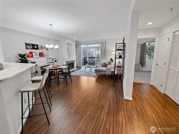 Another view of the main living area plus a view of the primary bedroom down the hallway to the right.